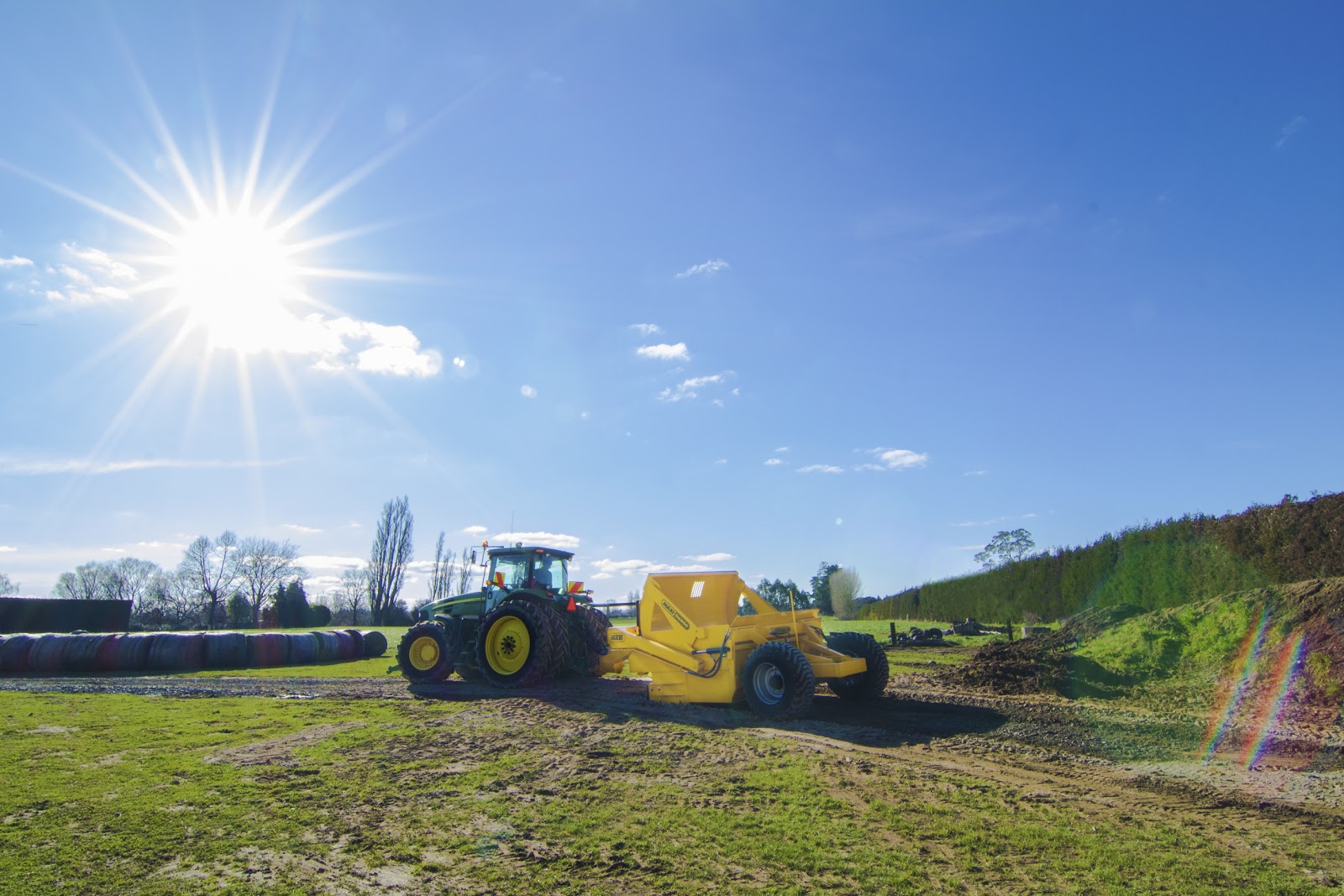 Tractor towing a scraper in a farm field in Cambridge